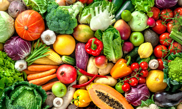 Assorted fresh vegetables including carrots, broccoli, tomatoes, and bell peppers.